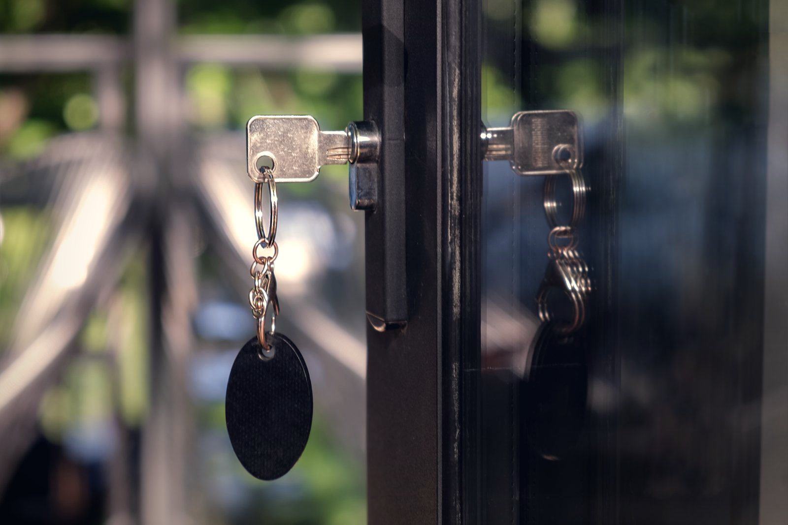 Hands fitting a brass lock plate to a wooden door with a screwdriver