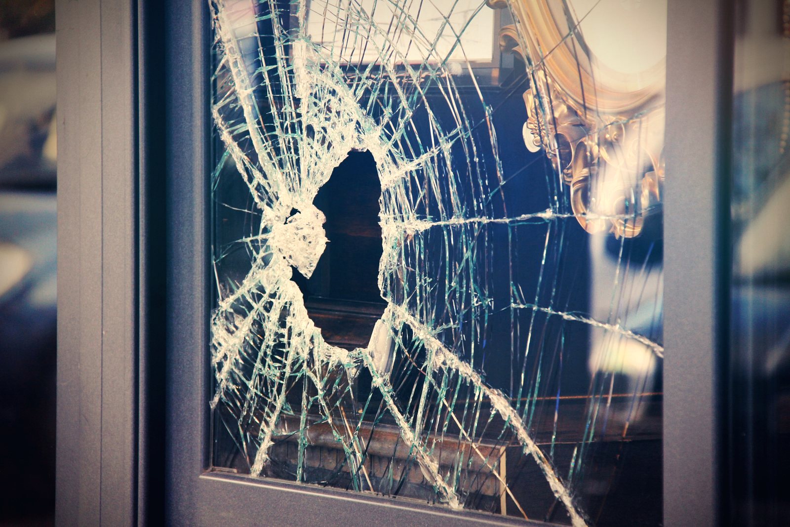 Tradesman repairing a damaged door frame after a break-in