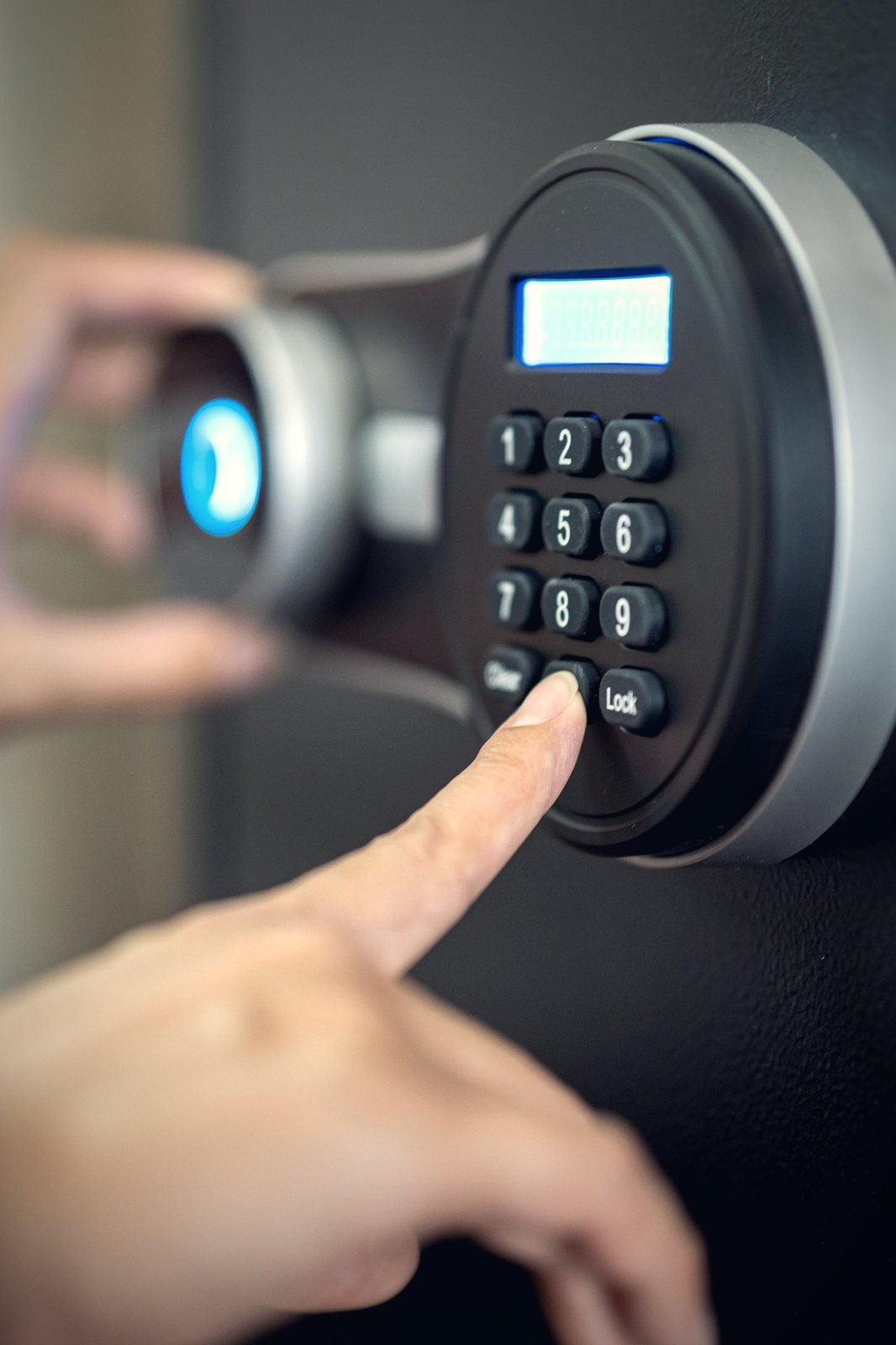 Modern office safe with a keypad and a set of keys on a desk